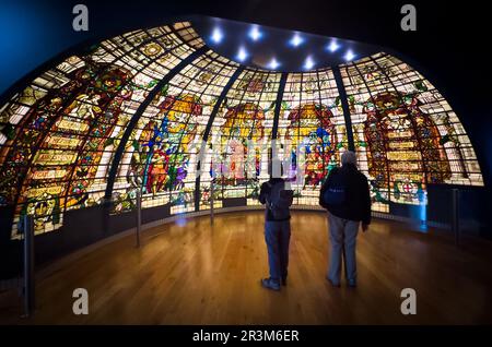 A middle-aged couple view the Baltic Exchange Memorial Glass on display at the National Maritime Museum (NMM) in Greenwich, London, UK. The elaborate Stock Photo