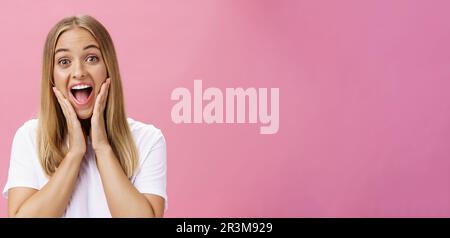 Portrait of amused and impressed curious attractive woman in t-shirt ...