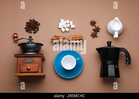 Flat lay composition with vintage manual grinder and geyser coffee maker on brown background Stock Photo