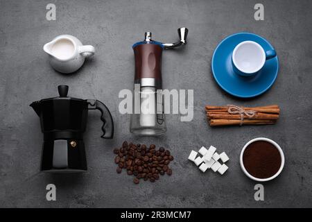 Flat lay composition with manual grinder and geyser coffee maker on black table Stock Photo