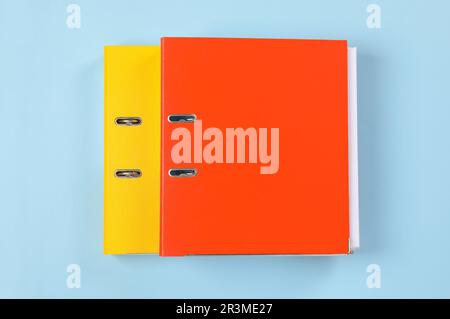 Office folders on light blue background, flat lay Stock Photo