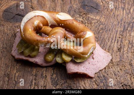 Meat loaf in a pretzel on wood Stock Photo