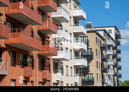 Red and white apartment buildings with many balconies seen in Berlin ...