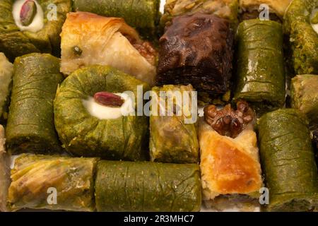 Turkish pistachio baklava isolated on a white background. A variety of turkish sweet baklava. Walnut baklava. Stock Photo