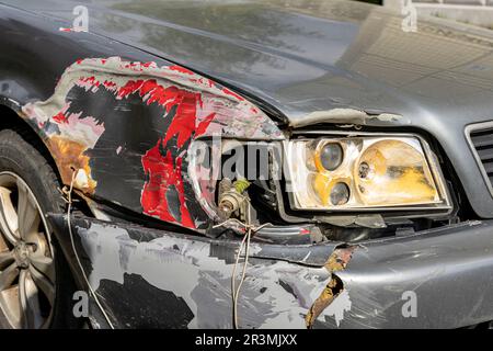 Broken Car after a Crash. Damaged Wing and Headlamp of a Car