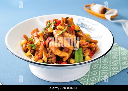 Chicken feet with hot Pepper on retro dark background.Delicious and unique Chinese food. Stock Photo