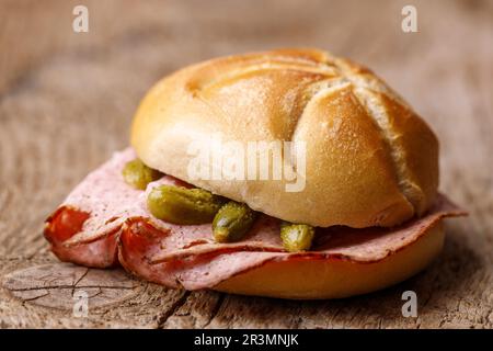 Bavarian liver cheese sandwich on dark wood Stock Photo