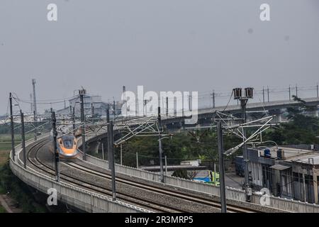 Bandung, Indonesia. 24th May, 2023. A bullet train bound for Jakarta station is seen during a trials at the Tegalluar station in Bandung, West Java, Indonesia on May 24, 2023. PT Kereta Api Indonesia China (KCIC) conducted a Hot Sliding Test on The CIT train from Tegalluar Station, Bandung Regency to Halim Jakarta Station, has an average maximum speed of 180 kilometers per hour. (Photo by Dimas Rachmatsyah/INA Photo Agency/Sipa USA) Credit: Sipa USA/Alamy Live News Stock Photo