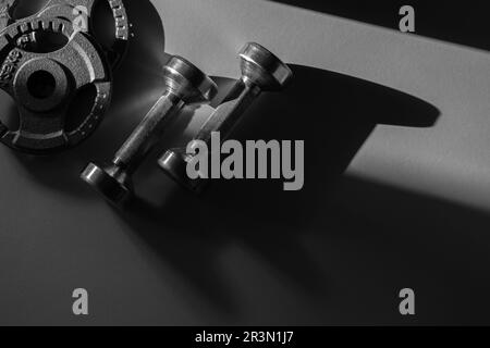 Close up of dumbbells on grey backgound. Sport and fitness equipment. Horizontal sport poster, greeting cards, headers, website. Stock Photo
