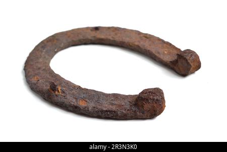 Old, rusty horseshoe isolated on white background. Stock Photo