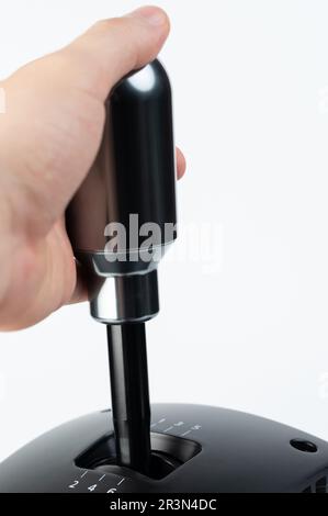 Sport car transmission handle shifter in hand isolated on white studio background Stock Photo