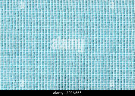 Woven glass fiber wallpaper against a blue background. Stock Photo