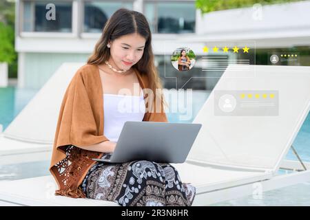 Businesswoman working outdoor using chatbot on computer with smart AI Stock Photo