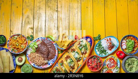 Mexican festive food for independence day independencia - chiles en nogada, tacos al pastor, chalupas pozole, tamales, chicken w Stock Photo