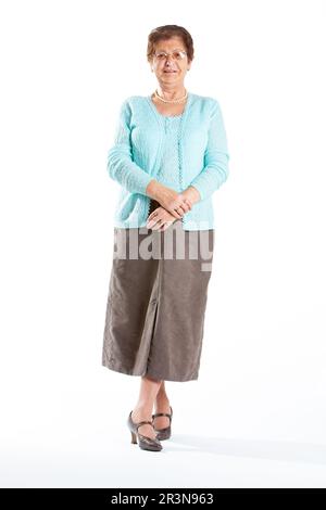 Senior Citizens: Elegant Lady. A casual pose from a friendly senior lady. Full length portrait, isolated on white. From a series of related images. Stock Photo