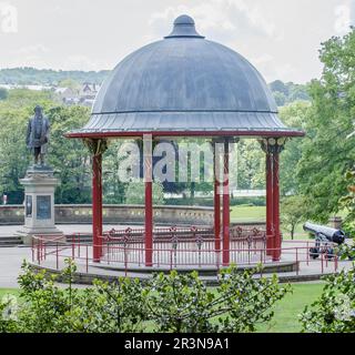 Roberts Park Bandstand, Saltaire, West Yorkshire. Saltaire is a UNESCO World Heritage Site. A statue of Sir Titus Salt is in the background. Stock Photo