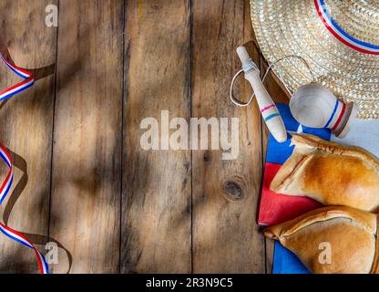 Chilean independence day concept. fiestas patrias. Tipical baked empanadas, wine or chicha, fat and play emboque. Decoration for Stock Photo