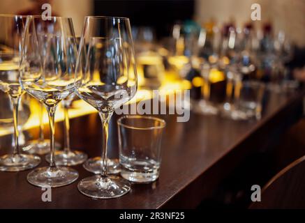 Glass goblets placed in rows on table during wine tasting procedure in restaurant Stock Photo