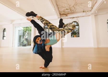 Image of caucasian female hip hop dancer practicing in studio Stock Photo