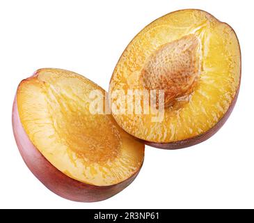 Halved red plum flying isolated on white background with clipping path Stock Photo