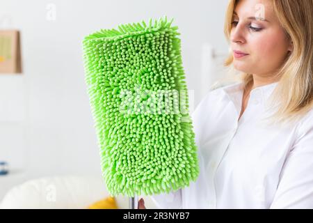 Portrait of housewife woman holds mop pad - cleaning concept Stock Photo