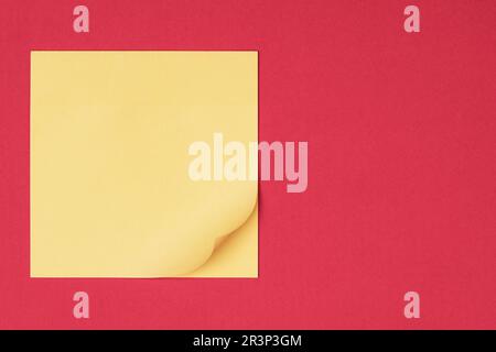 Yellow sticky note on red background waiting for your message Stock Photo