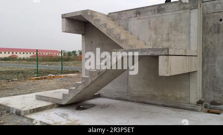 Picture of straight precast concrete stairs with landings completely installed on a building in the shell during the day Stock Photo