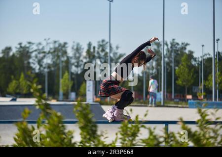 https://l450v.alamy.com/450v/2r3p668/young-roller-blader-female-grinding-on-a-rail-in-a-skatepark-cool-aggressive-inline-skater-person-performing-a-grind-trick-in-a-concrete-urban-park-2r3p668.jpg