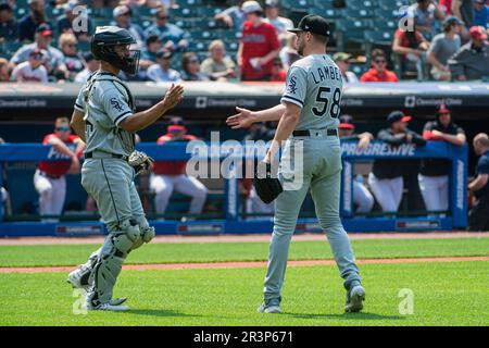 Chicago White Sox' Seby Zavala, left and relief pitcher Jimmy Lambert (58)  walk off the field after a win over the Cleveland Guardians at the end of a  baseball game in Cleveland