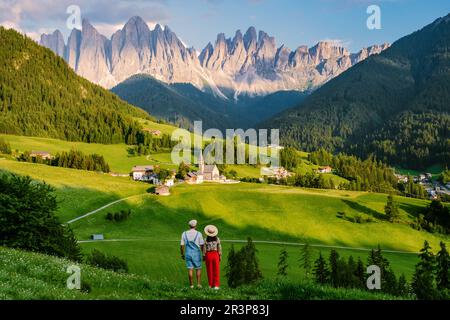 Couple viewing the landscape of Santa Maddalena Village in Dolomites Italy, Santa Magdalena village Stock Photo