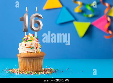 Candle number 16 - Cake birthday in blue background Stock Photo - Alamy