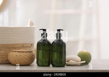 Green soap dispensers on white countertop in bathroom Stock Photo