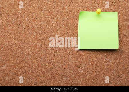 Blank paper note pinned to cork background. Space for text Stock Photo