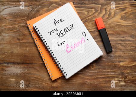 Notebooks with question ARE YOU READY FOR EXAM? and marker on brown wooden background Stock Photo