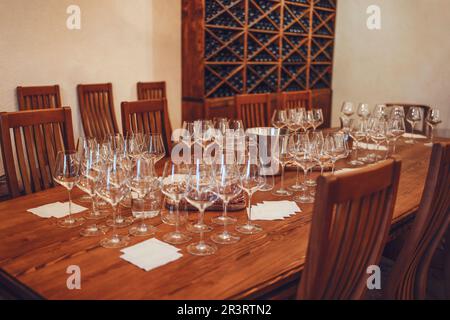 Glass goblets placed in rows on table during wine tasting procedure in restaurant Stock Photo