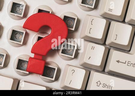 Close-up of a disassembled computer keyboard with a red question mark on it Stock Photo