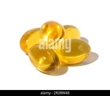 Yellow capsules with fish oil on a white background, close up Stock Photo