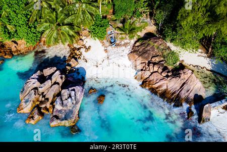 Drone view from above at a tropical beach in the Seychelles, Anse Volbert beach Praslin Stock Photo