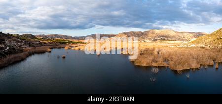 Panorama landscape of the Elche Reservoir lake in Alicante Province in warm evening light Stock Photo