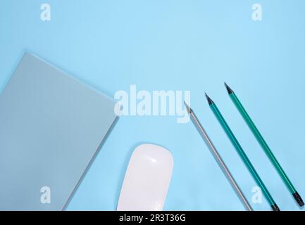 Blue notepad and wooden pencil on a blue background, Stock Photo