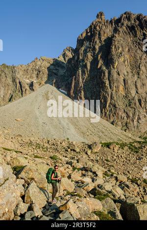 hiker on the road, Midi d'Ossau peak, 2884 meters, Pyrenees National Park, Pyrenees Atlantiques, France. Stock Photo