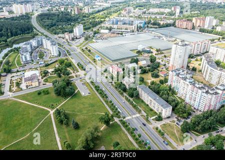 aerial side view of large industrial greenhouse for growing vegetables and plants in residential area Stock Photo