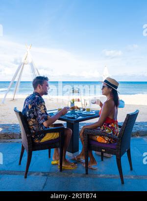 Luxury breakfast on the beach of Phuket Thailand, couple having breakfast outdoor on the beach Stock Photo