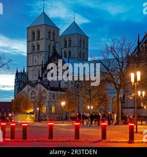 Glowing red bollards as a barrier to parking with St. Paul's Cathedral, Muenster, Germany, Europe Stock Photo