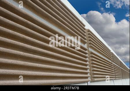 A modern soundproof wall with cloudy sky in background Stock Photo