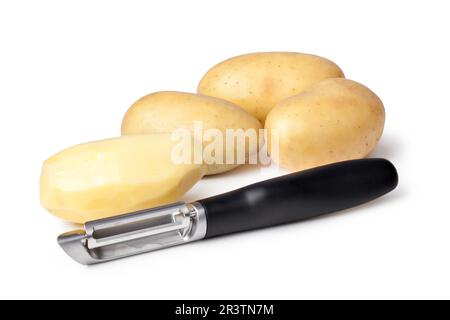 Potatoes and Peeler on a white background Stock Photo