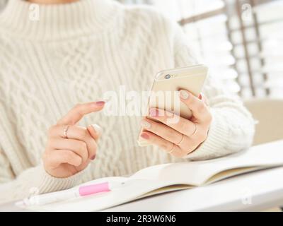 Hands of Asian women using smartphones Stock Photo