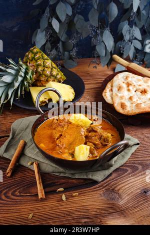 Traditional spicy Indian chicken Madras curry Rogan Josh with drumsticks Stock Photo