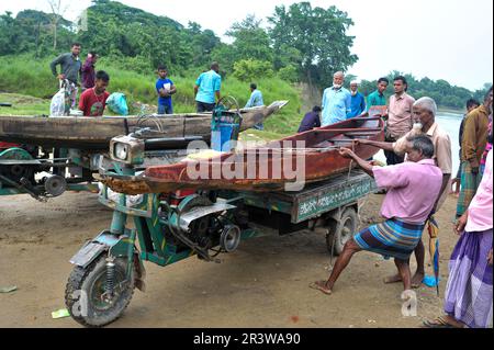 The monsoon season is approaching. The residents of Gowainghat upazila of Sylhet have to travel almost everywhere by boat. Therefore, as an advance preparation, a villager is buying a boat from the Salutikar market of Nandir Gao Union of Guainghat Upazila. Each boat is being sold at this market for 5000-7000 TK, depending on the size. Sylhet, Bangladesh. Stock Photo