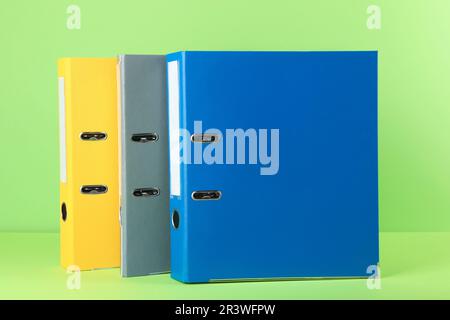 Bright hardcover office folders on light green background Stock Photo